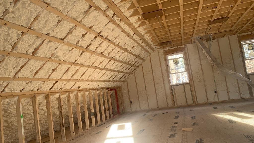 Wide view of attic insulated with spray foam by Sergio's Insulation